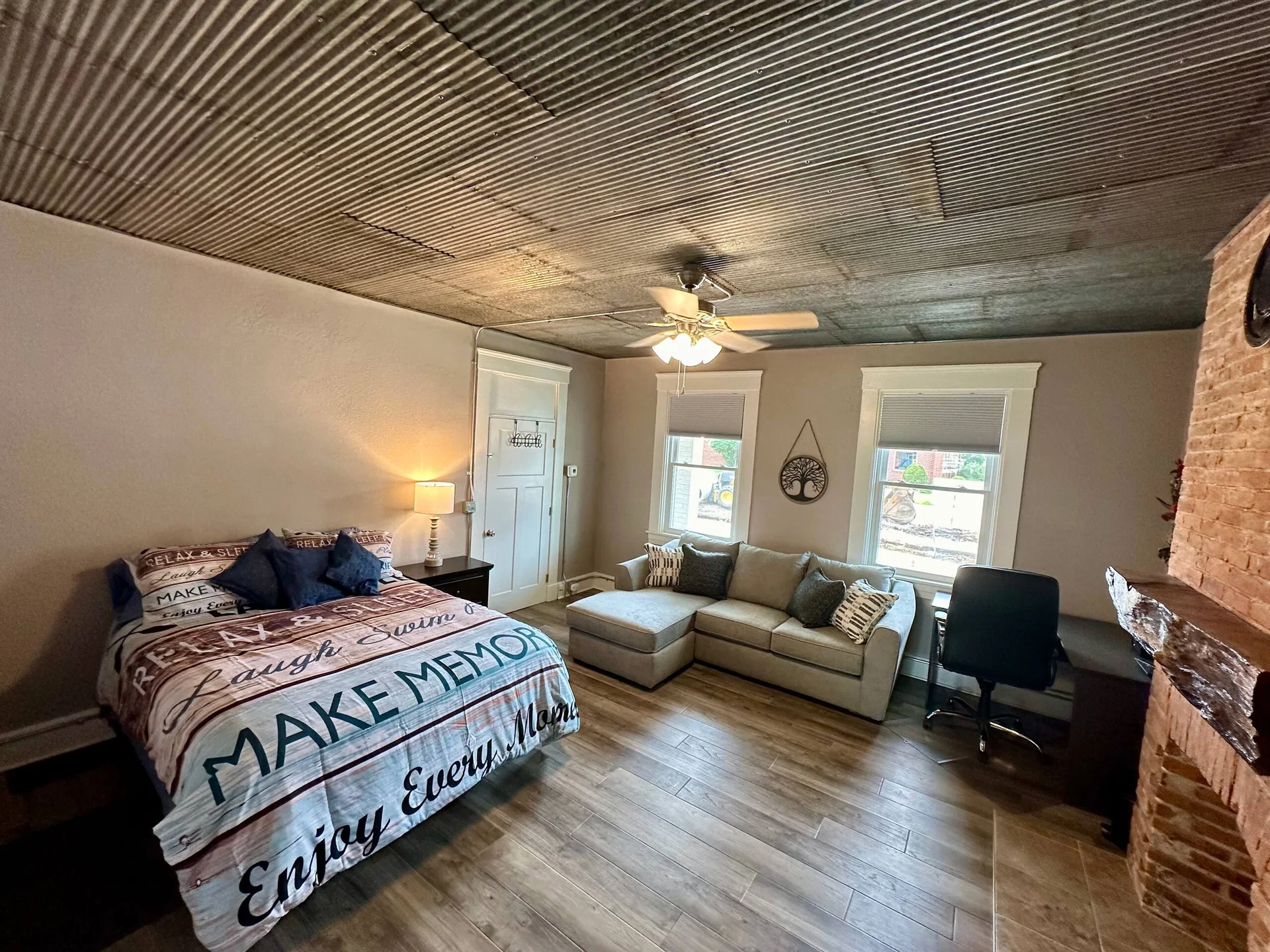 Queen bed, lounge seating and dedicated desk in Hayden’s Hideout